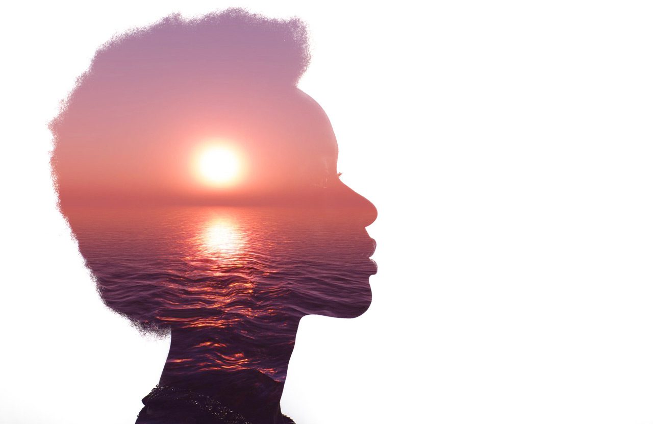Multiple-exposure-image-with-sunrise-and-sea-inside-female-silhouette