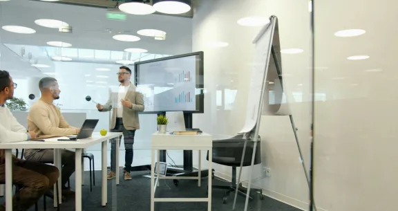 Leader applying trainer certification skills during a boardroom discussion