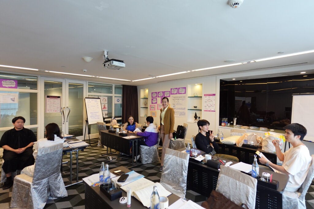 Lakkana, NLP trainer teaching a group of students working toward Practitioner certification