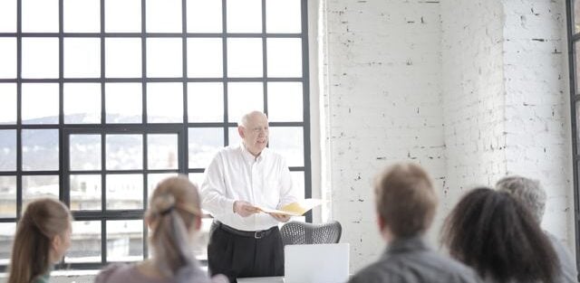 Leader communicating organisational change to a seated team